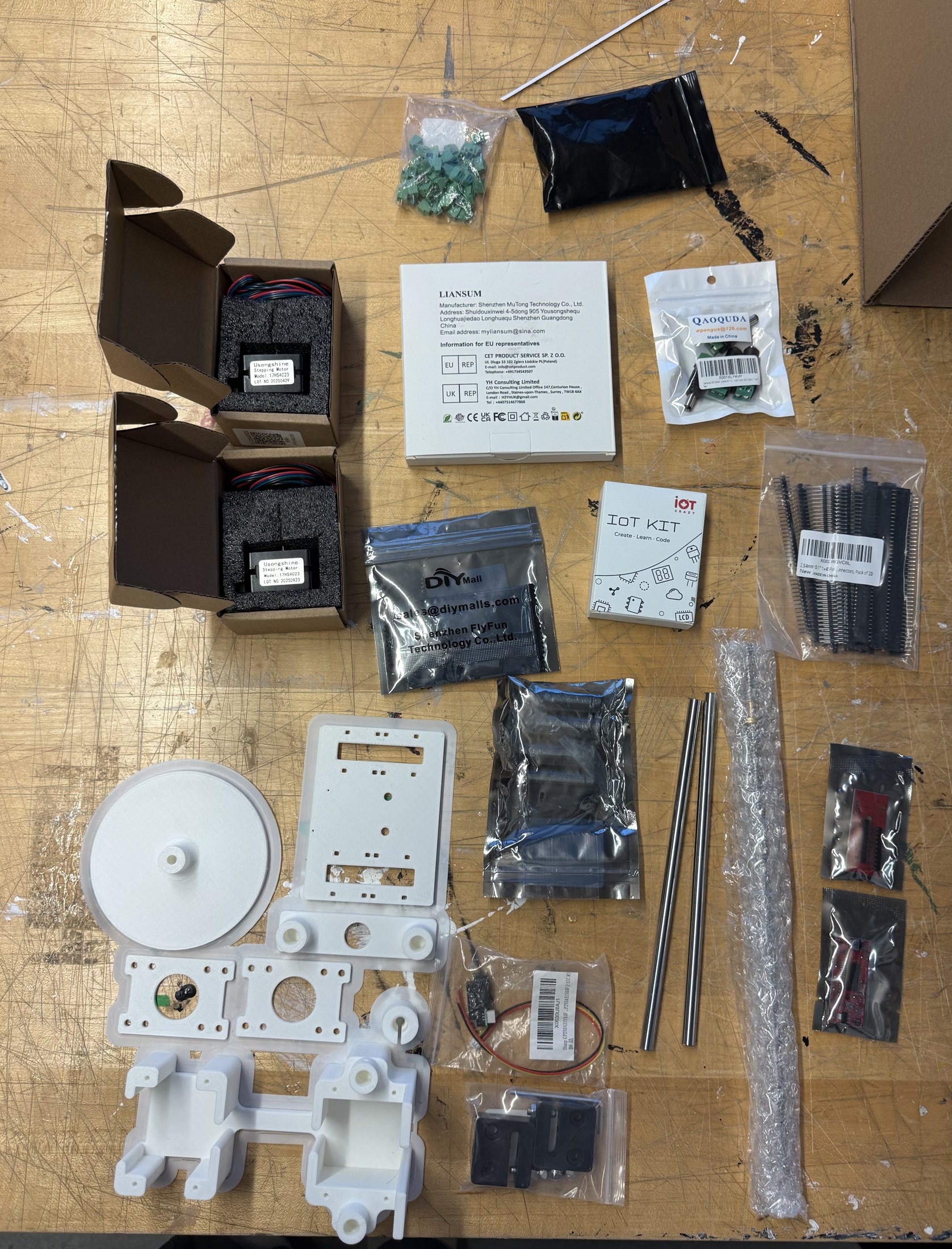 Scanner hardware and fabricated parts laid out before assembly