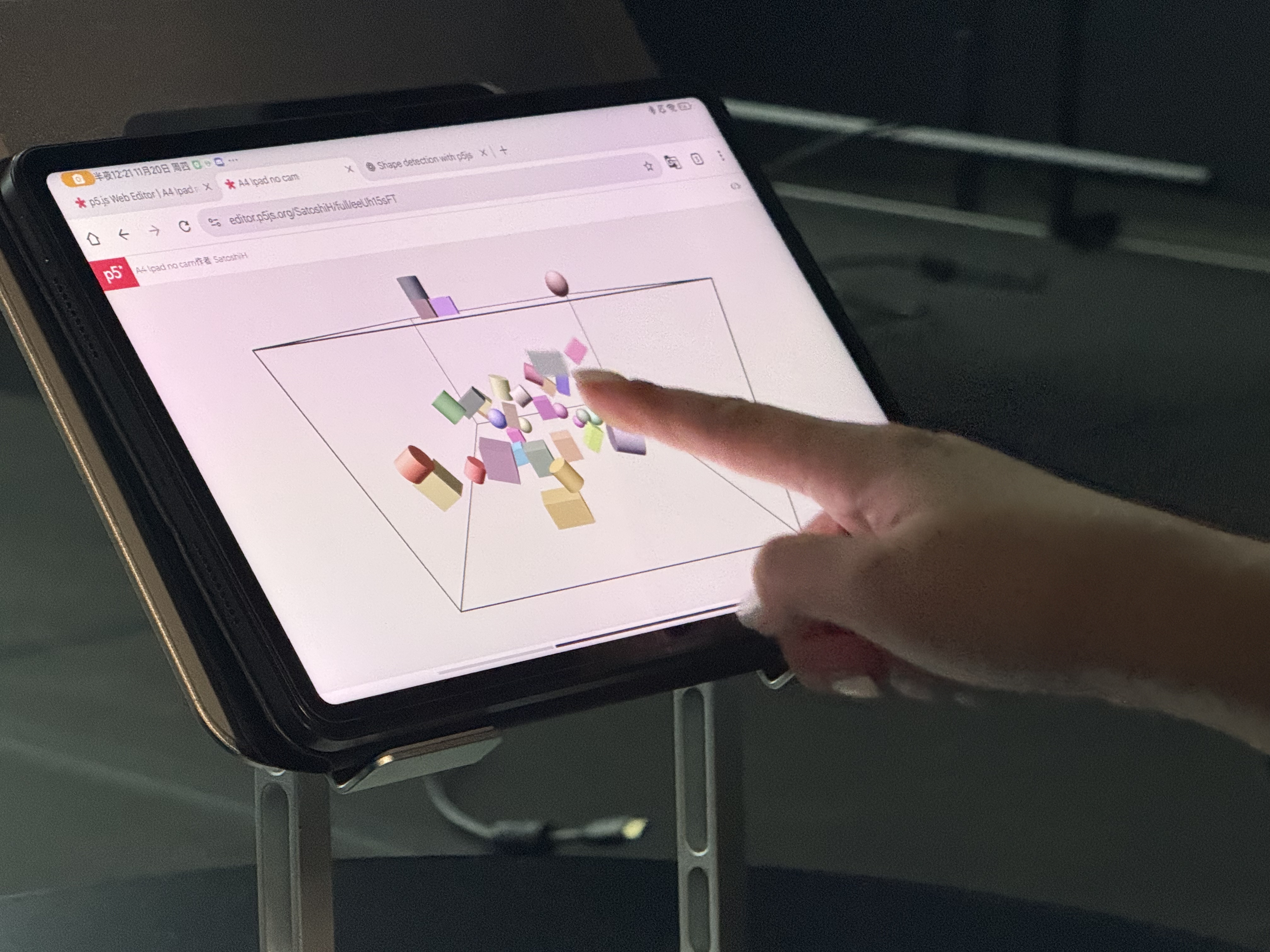 Participant using hand gestures to arrange blocks in the Sketch-a-room installation